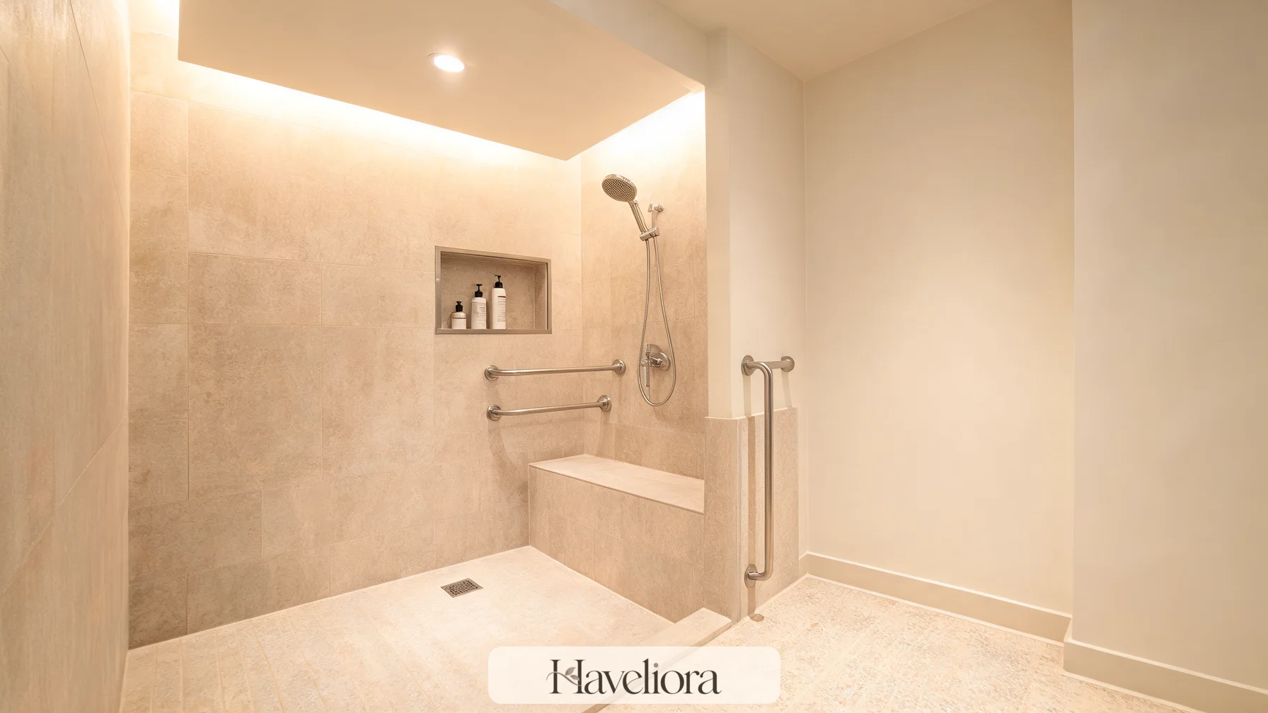 Accessible open shower with a built-in bench, grab bars and handheld shower.