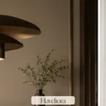 Playful sophisticated room with a sculptural pendant, strong geometry and edited warm materials.