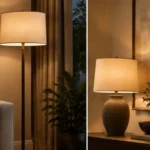 Floor lamp beside a sofa creating a focused pool of warm light.