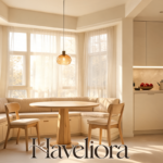 Warm kitchen with an upholstered built-in banquette, round pedestal table and two dining chairs.